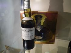 Vintage bottle of black and white Choice old Scotch whisky, some loss, and a bottle of Krzesk