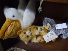 Collection of Steiff plush toys including cat, pelican and tabby cat