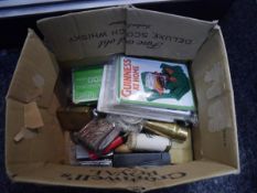 Box containing a collection of novelty lighters, playing cards, Deuchars key fob, cased cigarette