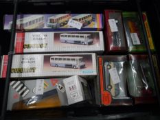 Crate containing a collection of boxed model vehicles including Volvo coach