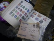 Three albums containing world stamps c1930, together with a group of stamped postcards and letters