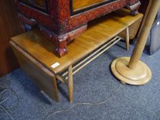 Mid 20th century Ercol elm twin drop leaf two tier coffee table raised on turned supports