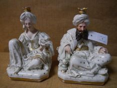 A pair of Jacob Petit porcelain figural scent bottles, c. 1870, modelled as seated Turkish