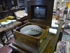 Marquetry inlaid walnut Polyhphon, late 19th century, the table top musical disc player playing from