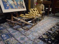 Late 19th/early 20th century iron and pine sledge, with planked seat and steering bar. Length 1.43m