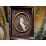 Portrait miniature of a young gentleman, c. 1820, dressed in a brass-buttoned blue coat, watercolour