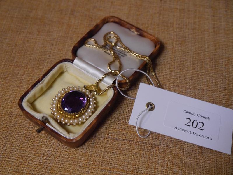 Mid-19th century gold, amethyst and seed pearl brooch/pendant, the large oval-cut amethyst within