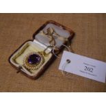 Mid-19th century gold, amethyst and seed pearl brooch/pendant, the large oval-cut amethyst within