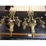 Pair of gilt metal and painted toleware wall lights, each ribbon-tied terminal and issuing a pair of