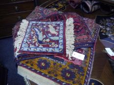 Pair of Turkeman style saddle bag panels, a small mat with floral and bird design, a Turkeman mat