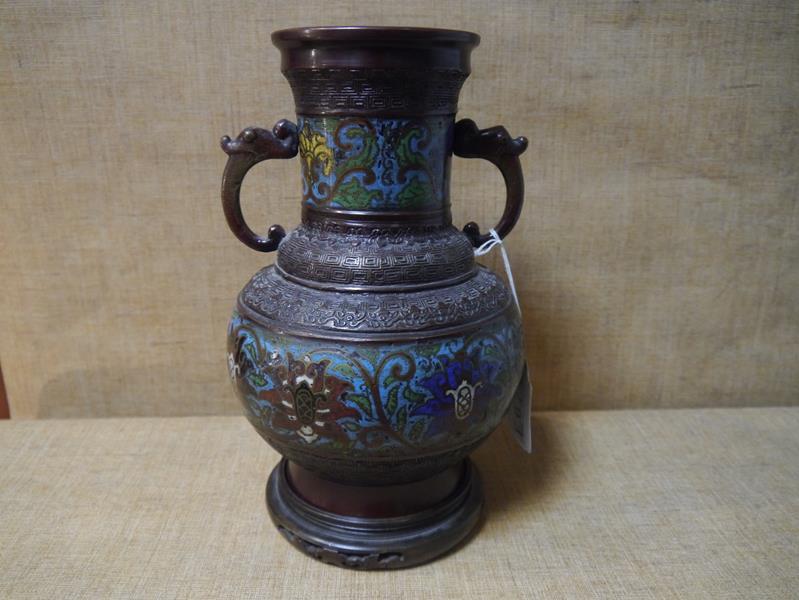 A Chinese bronze and cloisonne enamel twin-handled vase, c. 1900, of baluster form, with