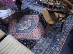 Machine-woven Shiraz style rug, centre medallion enclosing within foliate panel and triple foliate