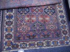 Caucasian rug, the centre panel with three rows of interlocking octagons and stylised foliate