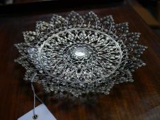 Late 19th century Indian pierced dish, centred by a Victorian Indian coin within elaborate wirework,