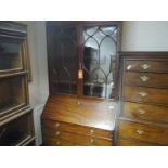 George III mahogany bureau bookcase, c. 1800, the moulded cornice above a plain frieze over a pair