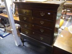 A George III mahogany chest on stand, with moulded dentilled cornice above a fretwork-carved