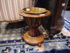 Late 19th century walnut wine cooler, of circular form, with (replaced) brass liner and swing handle