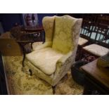 George III style mahogany framed wing chair, c. 1900, with scrolled crest rail and loose cushioned