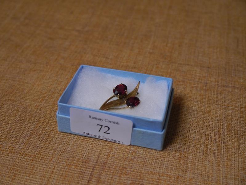 9ct gold and garnet brooch, set with a pair of oval cut garnets.