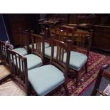 Set of six mahogany dining chairs in the Arts and Crafts taste, each back with capped uprights and
