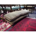 Early 20th century walnut-framed fireside stool, with loose cushioned seat and raised on short