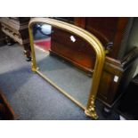 Giltwood overmantle mirror in 19th century style, with arched top and scroll-carved base. 0.90m by