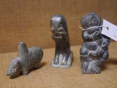 Three inuit stone carvings, one of an otter eating a fish, signed Jimmy Smith, another with mother