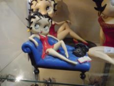 A Betty Boop composition figure on a chaise with telephone
