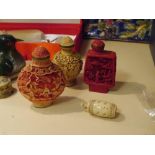 Two Chinese faux ivory snuff bottles together with a cinnabar lacquer Chinese snuff bottle