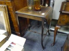 An Edwardian bone inlaid rosewood dropleaf side table with block carved stretchers and moving on
