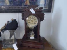 An Ansonia gingerbread mantel clock, late 19th century, the dial with Roman numerals, striking on