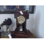 An Ansonia gingerbread mantel clock, late 19th century, the dial with Roman numerals, striking on