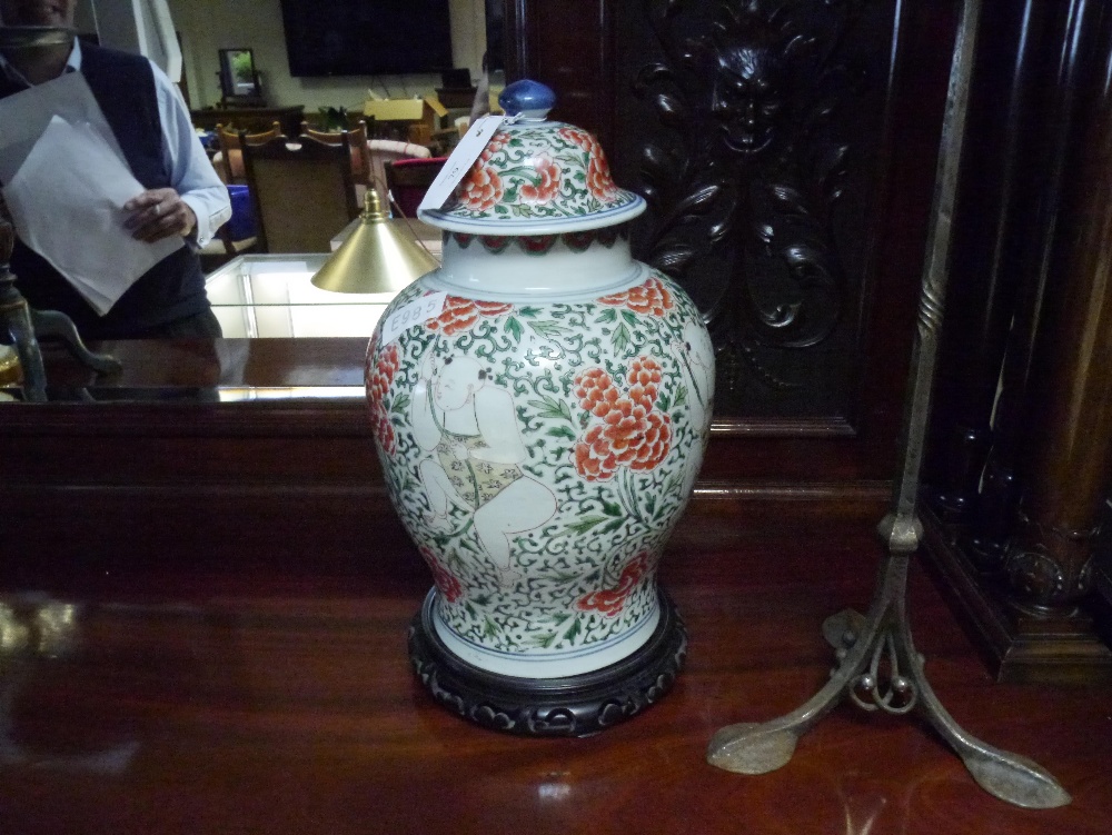 A Chinese porcelain baluster jar and cover in the famille rose palette decorated with figures