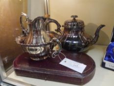 A group of Elkingtons silver plate comprising a three piece tea service and a cased pair of servers