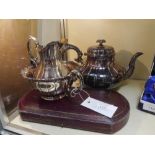 A group of Elkingtons silver plate comprising a three piece tea service and a cased pair of servers