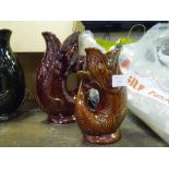 Two Dartmouth fish glug jugs, large and small, brown glazed