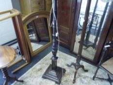 An Edwardian mahogany standard lamp with turned column on square base