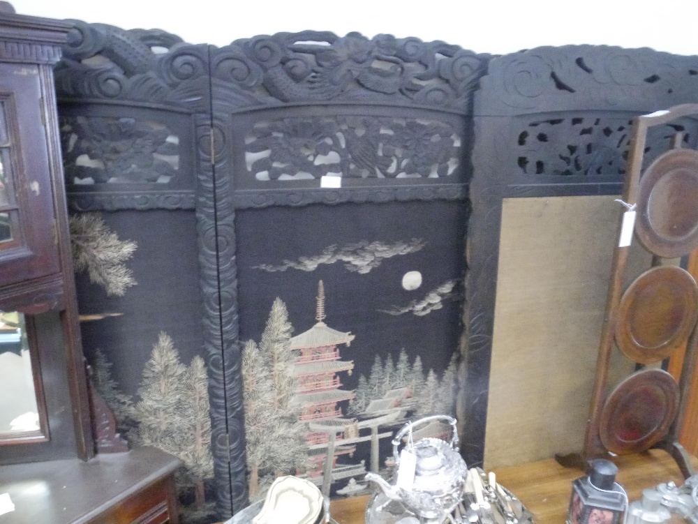 A 1920s Chinese hardwood and silk four panel screen, the panels worked with a pagoda and other