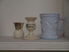 Two thistle form pieces of crested ware, a Swan China candlestick for Turriff, Aberdeenshire and a