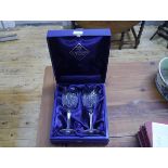 A cased pair of Edinburgh Crystal goblets, the bowls with pointed arch diamond cut panels on