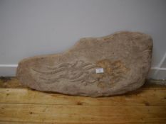 A sandstone carving, of naturalistic form, carved with an abstract design in relief. 76cm by 34cm