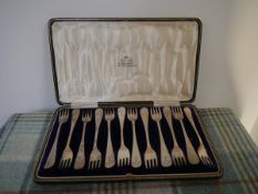 A cased set of twelve silver pickle of cocktail forks, bearing the arms of the Hay family, Sheffield