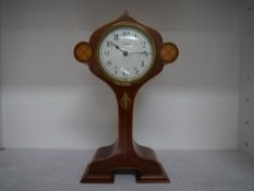 An abalone and boxwood inlaid mahogany mantel clock in the Art Nouveau taste, the circular dial