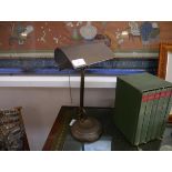 A mid-20th century patinated metal adjustable desk lamp, with integral metal shade, articulated