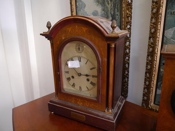 An Edwardian inlaid mahogany mantel clock, the silvered arch top dial with Roman numerals and