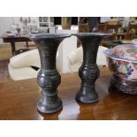 A pair of Japanese bronze vases, Meiji period each with flared rim, baluster knop and dome foot,