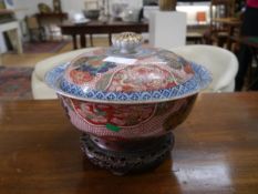 A Japanese porcelain bowl and cover, probably early 19th century, the domed cover with pierced