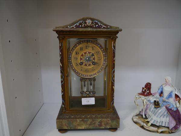 A French late 19th century champleve enamel and onyx mantel clock, the gilt dial with Roman numerals