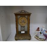 A French late 19th century champleve enamel and onyx mantel clock, the gilt dial with Roman numerals