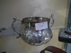 An early Charles II silver twin-handled porringer, maker IG, London 1666, of baluster form, repousse